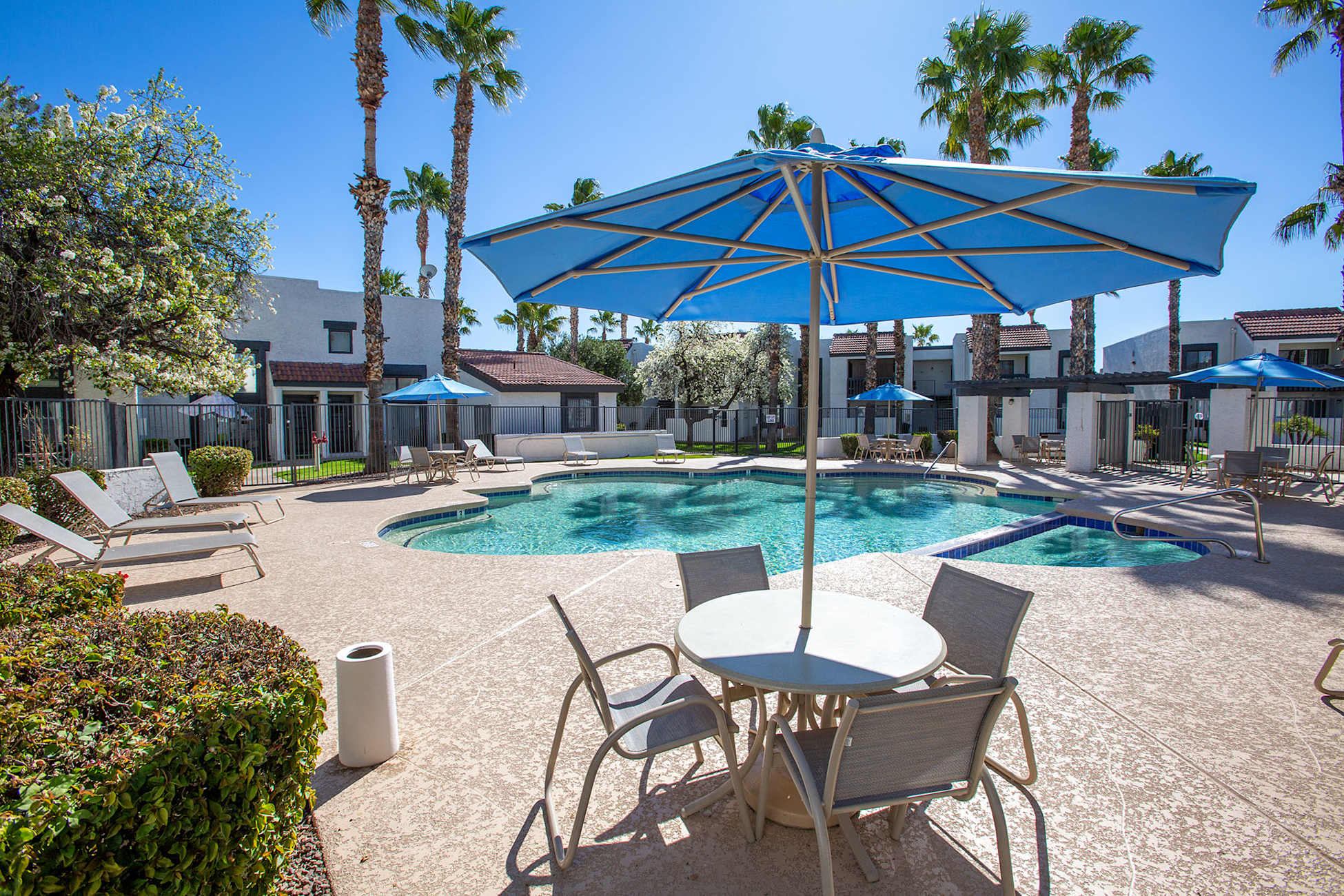 Pool and poolside area at Townhomes on the Park Apartment Homes.