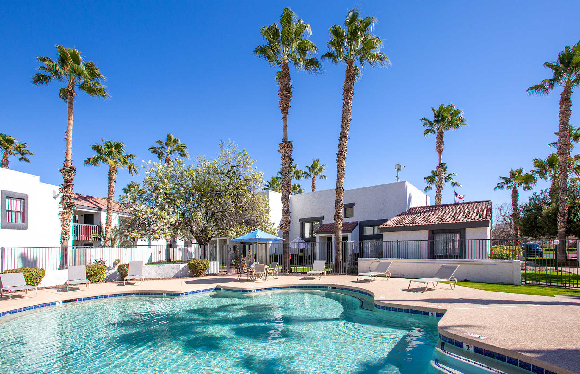 Pool and poolside area at Townhomes on the Park Apartment Homes.