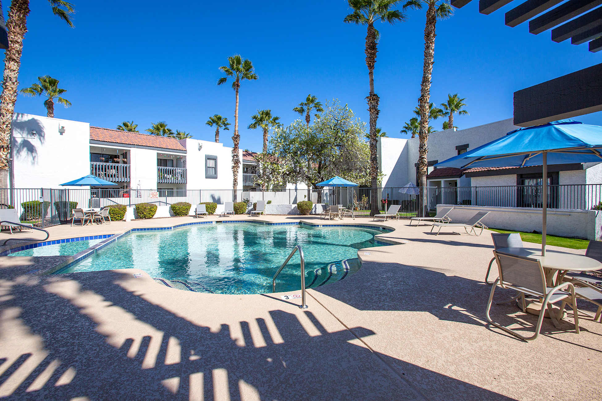 Pool and poolside area at Townhomes on the Park Apartment Homes.
