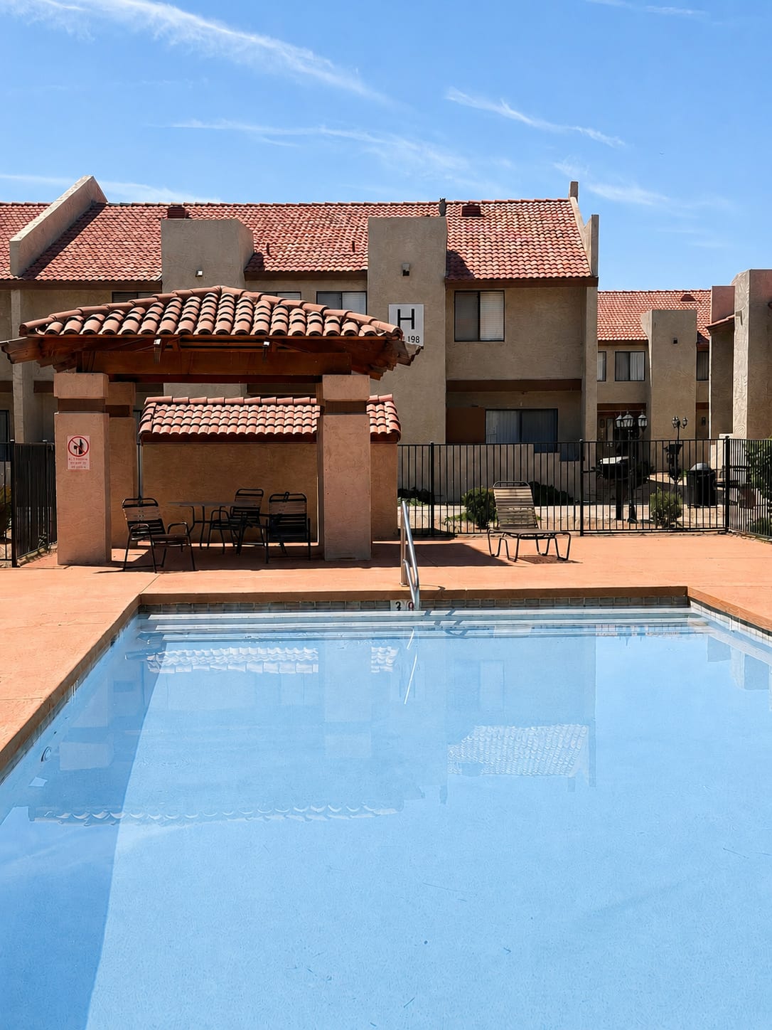 Pool and poolside area at Windsprings Apartments.
