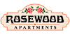 A sign that says Rosewood Apartments with two roses on it.