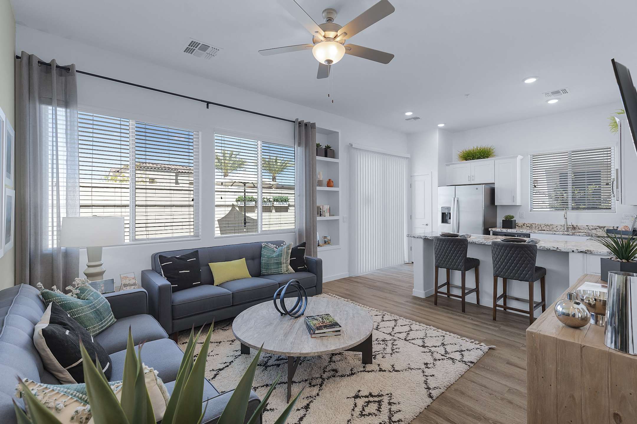 Furnished apartment living area shown — representative home at Avilla Magnolia.