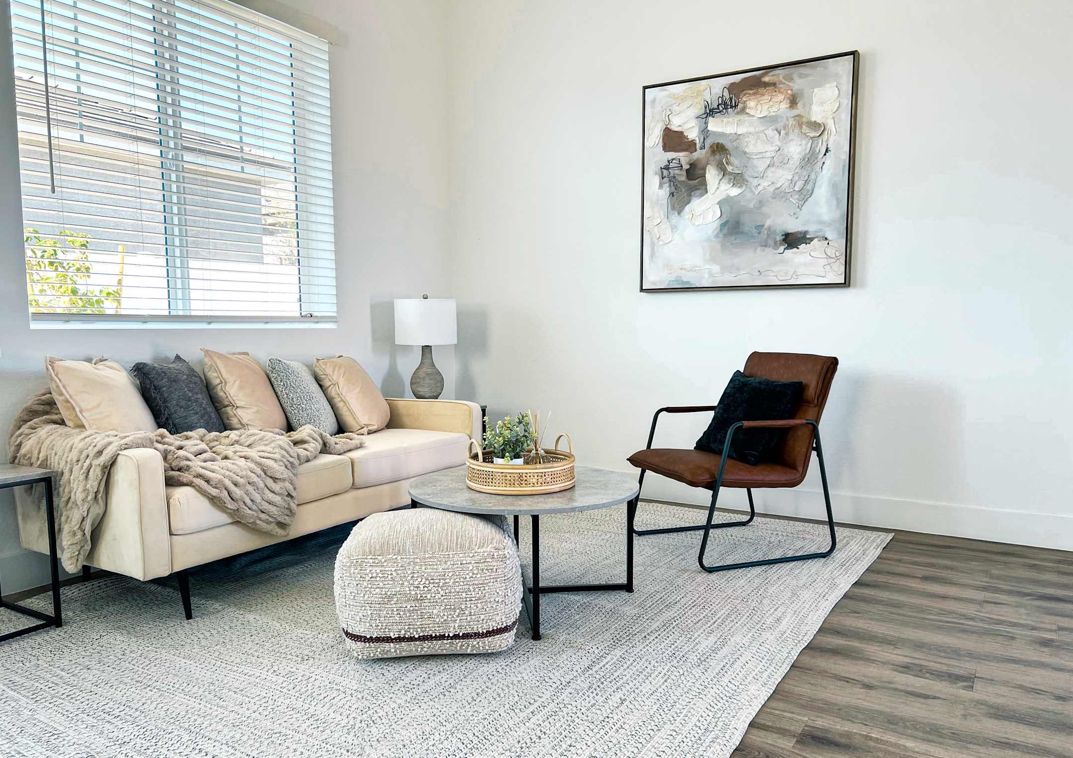 Furnished apartment living area shown — representative home at Zora Encanto.