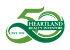 The image is a logo for Heartland Realty Investors, established in 1976.
