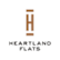 A logo with a brown heart shaped figure above the words "Heartland Flats".