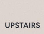 a sign that says upstarts on the side of a building