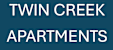 A sign that says Twin Creek Apartments.