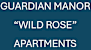 A sign that says Guardian Manor Wild Rose Apartments.