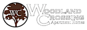 The image is a logo for Woodland Crossing Apartment Homes.