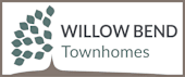 A logo for Willow Bend Townhomes with a tree and a group of houses.