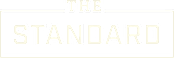 A green sign with the words "The Standard" written in white.