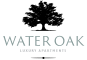 a logo for water oak luxury apartments with a tree