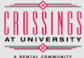 A sign that says "Crossings at University" in pink and black.