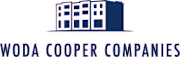 A blue and white logo of a building with the text "WODA COOPER COMPANIES" below it.