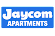 A blue sign with the text "Jaycom Apartments" on it.