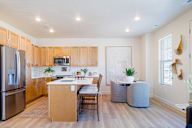A kitchen with wooden cabinets and a refrigerator.