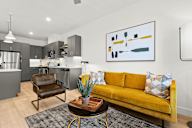 Sacramento, CA Luxury Apartments for Rent - The Eisley - Living Room with Wood-Style Floors, an Open Floor Plan, and a Ceiling Fan