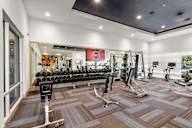 One-Bedroom Apartments in Sacramento, CA - The Eisley - Fitness Center with Stationary Bikes, Free Weights, Benches, and Large Mirror Wall with High Ceilings