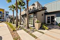 the estates ext apartment building entrance with palm trees