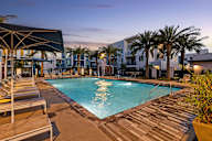 a swimming pool at a resort with palm trees