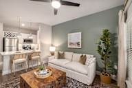 an open living room and kitchen with a couch and a table
