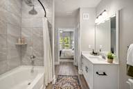 a bathroom with a shower and a sink and a bath tub