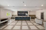a clubhouse with a bar and seating area with chairs and a table