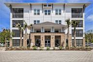 an image of a building with palm trees in front of it