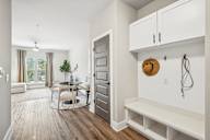 a living room with a door to a dining room and a table