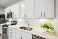 a kitchen with white cabinets and a sink