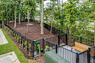 a park with benches and a fence