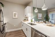 A kitchen with white cabinets and a stainless steel dishwasher.