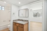 A bathroom with a sink, mirror, and toilet.