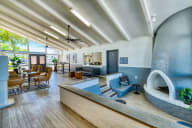 a living room with a fireplace and a table and chairs at Connect on Missouri, Arizona