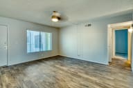 an empty living room with wood flooring and a window at Connect on Missouri, Phoenix