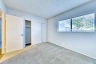 an empty room with a large window and a door to a closet at Connect on Missouri, Arizona