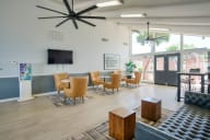 a living room with a table and chairs and a television at Connect on Missouri, Phoenix, AZ 85015