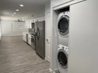 A row of washing machines in a laundry room.