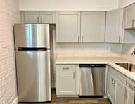 A kitchen with a stainless steel refrigerator and dishwasher.