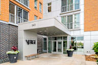 the front entrance of a building with the verge building name on it at Verge Apartments in St. Louis Park, MN