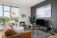 a living room with a couch and a television at Verge Apartments in St. Louis Park, MN