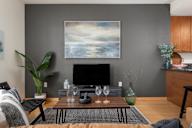 a living room with a coffee table and a television at Verge Apartments in St. Louis Park, MN