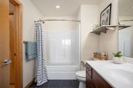 a bathroom with a shower and a sink and a toilet at Verge Apartments in St. Louis Park, MN