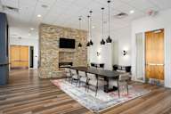 a dining room with a table and chairs and a fireplace at Verge Apartments in St. Louis Park, MN