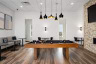 a games room with a pool table and a tv at Verge Apartments in St. Louis Park, MN