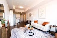 A living room with a white couch and a coffee table.