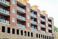 A multi-story building with balconies and windows.