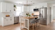 A rendering of the townhouse kitchens, with white cabinets and stainless steel appliances.