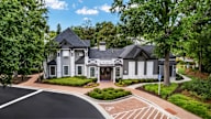 A large house with a driveway in front of it.
