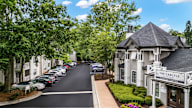 A street view of a residential area with a building named "The Carlyle".